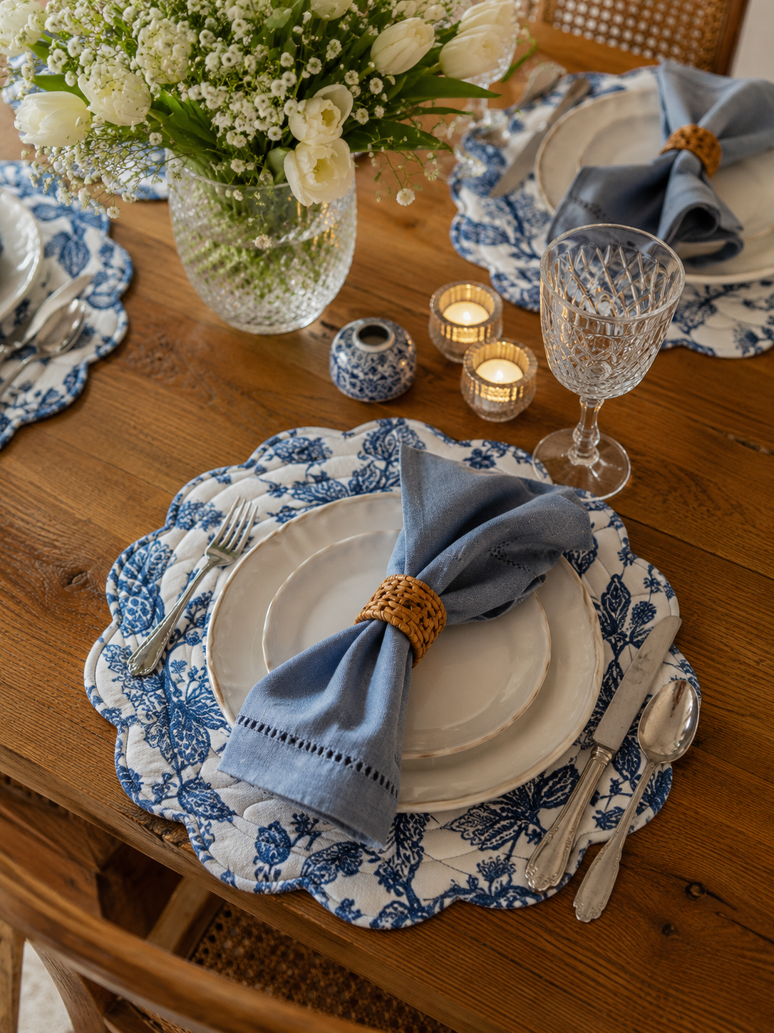 Table setting with Blue and white quilted placemats with scalloped edges