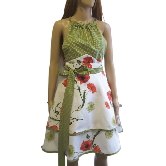 A flirty retro style apron with a poppies print featuring a light skirt with poppy flowers on a white background and a green polka dot bib, apron Poppy by Katrushka, handmade in Slovenia