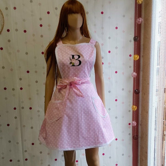  Pink apron with a sweetheart neckline, polka dot pattern, and two pockets.
Large monogram embroidery on a bib, apron Barbara by Katrushka, made in Slovenia