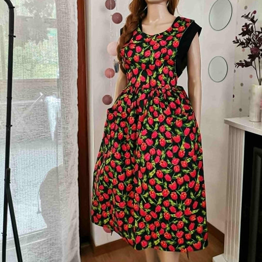 wrap around apron dress with a red tulip print on and black 
