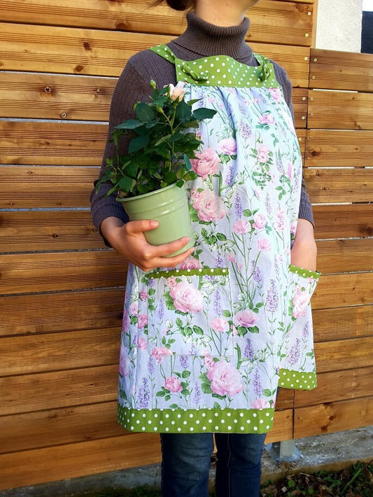 Easy-on apron in soft mint colour with roses print, two large pockets and adjustable neck straps